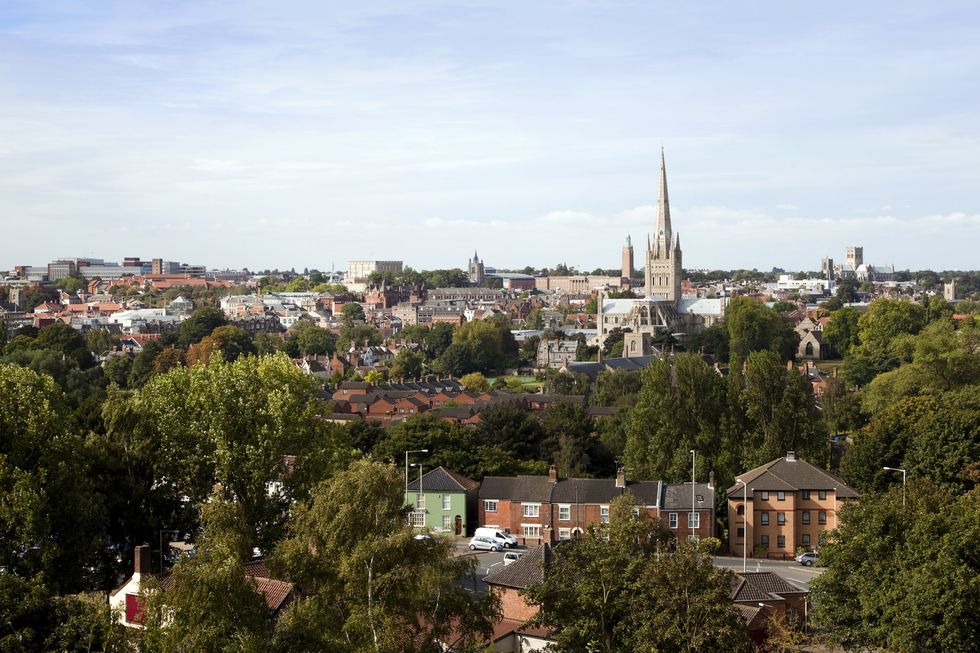 a view over the city of norwich, in norfolk, england, from mousehold heath the main landmark buildings seen here are from left to right, st peter mancroft church, norwich city hall, norwich cathedral and norwich roman catholic cathdral many ancient buildings can also be seen