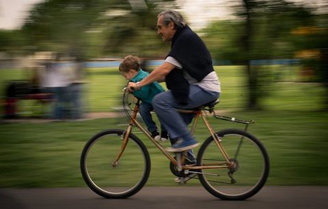 An older and younger cyclist. 