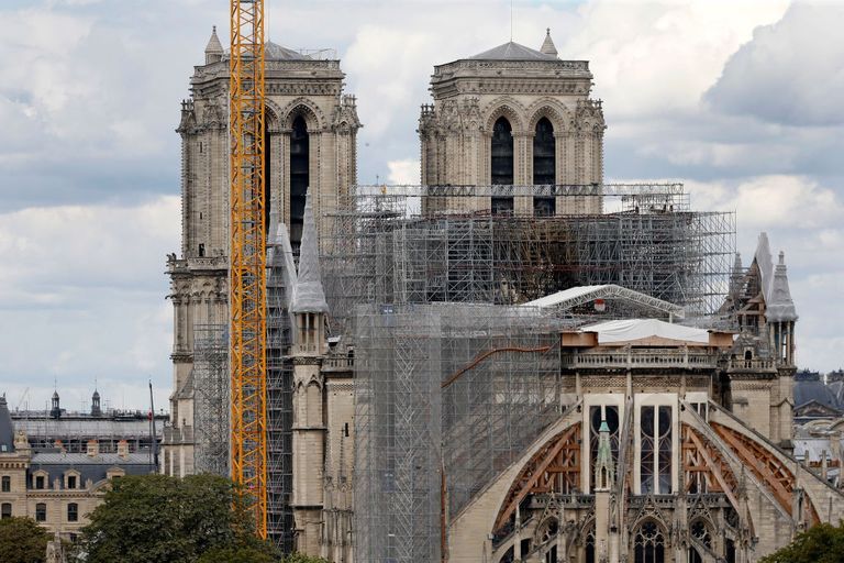 notre dame cathedral should be rebuilt identically by using traditional techniques and materials