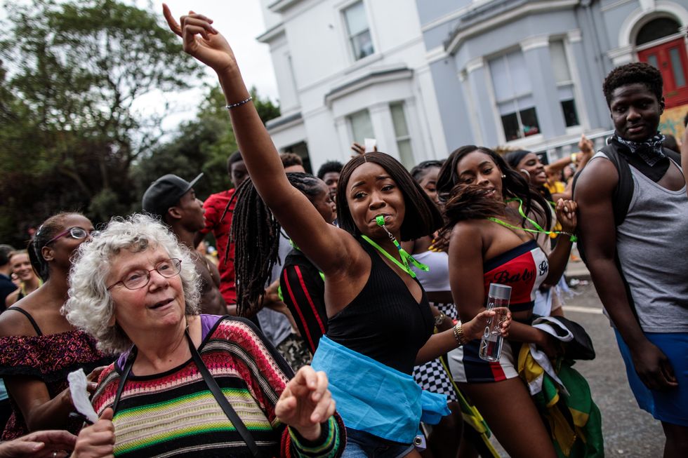 london, england   august 27 revellers dance on the final day of the notting hill carnival on august 27, 2018 in london, england the notting hill carnival, which has taken place annually since 1964, is expected to attract around a million people over the bank holiday weekend the two day event, started by members of the afro caribbean community, sees costumed performers take to the streets in a parade and dozens of sound systems set up around the notting hill streets photo by jack taylorgetty images