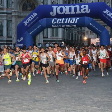 runners participating in a race under an inflatable startfinish archway runners participating in a race under an inflatable startfinish archway