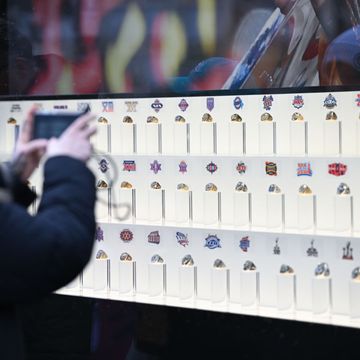 fan takes picture of super bowl ring display