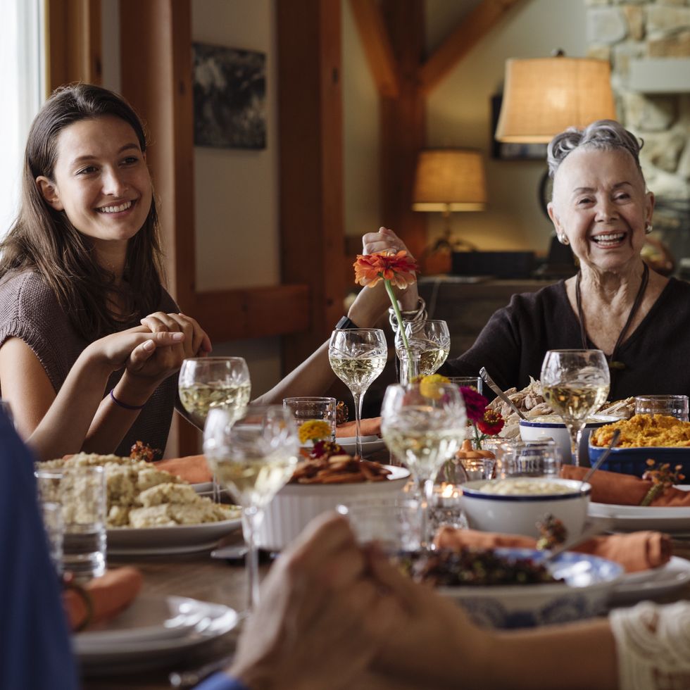 november holidays  family sitting at thanksgiving table