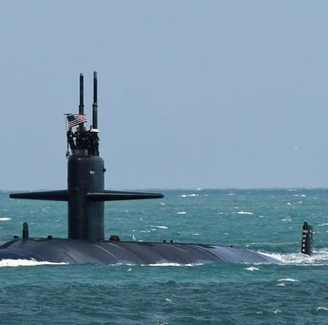 a nuclear powered us navy submarine cruises into the navy