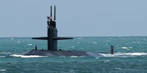 a nuclear powered us navy submarine cruises into the navy