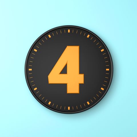 number 4 over black wall clock on blue background