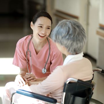 nurse caring for senior woman in wheelchair