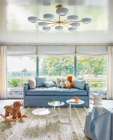 midcentury modern ranch home in millbrook, new york nursery chandelier custom shade fabric otis textiles with samuel  sons trim floor lamp circa lighting, with custom shade in kravet fabric daybed custom, charles h beckley, in pierre frey linen, with custom pillows in galbraith  paul large printed, john robshaw small printed, and kravet small ticking fabrics rug and side table serena  lily coffee table custom