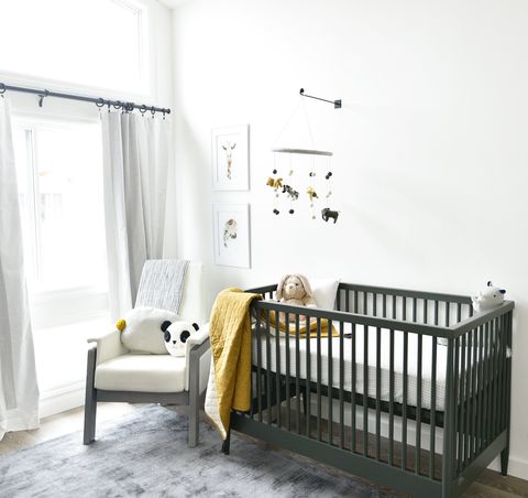 a white and gray glider in a baby nursery setting