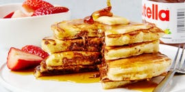 three pancakes stuffed with nutella and topped with butter and syrup