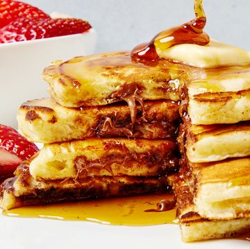 three pancakes stuffed with nutella and topped with butter and syrup
