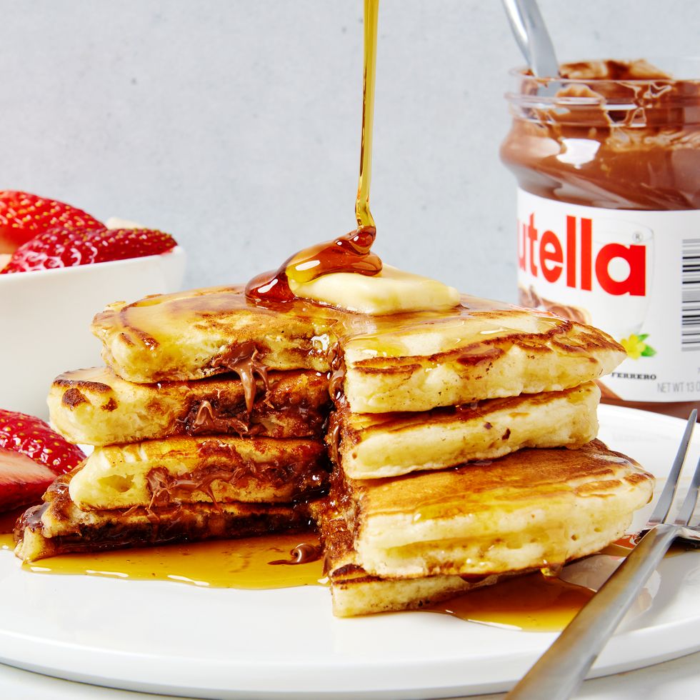 triple stack of pancakes stuffed with nutella and topped with butter and syrup