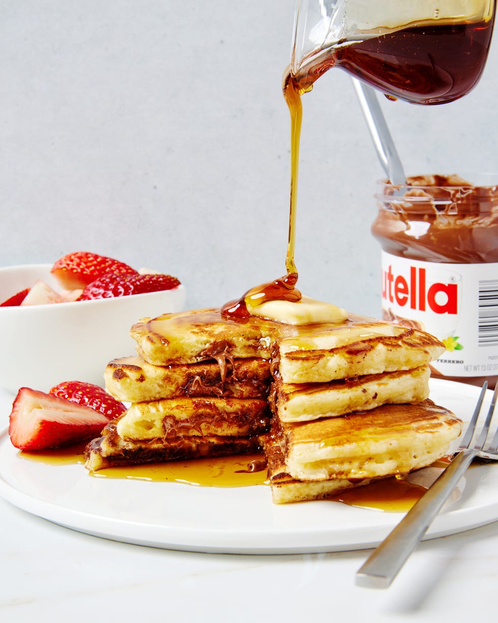 Three pancakes stuffed with Nutella and covered with butter and syrup