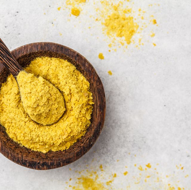 nutritional yeast in a wooden bowl, copy space healthy vegan food concept