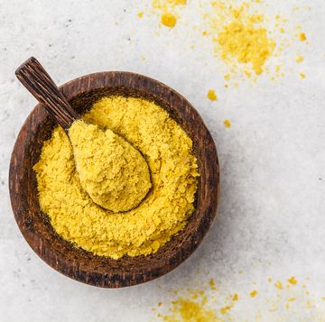 nutritional yeast in a wooden bowl, copy space healthy vegan food concept