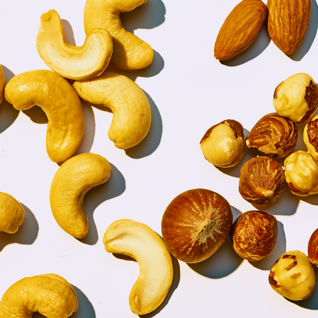 several different kinds of nuts on a gray background