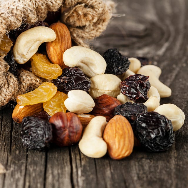 nuts and dried fruits on wooden background