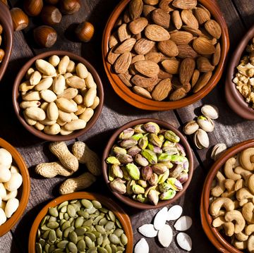 nuts assortment on rustic wood table.