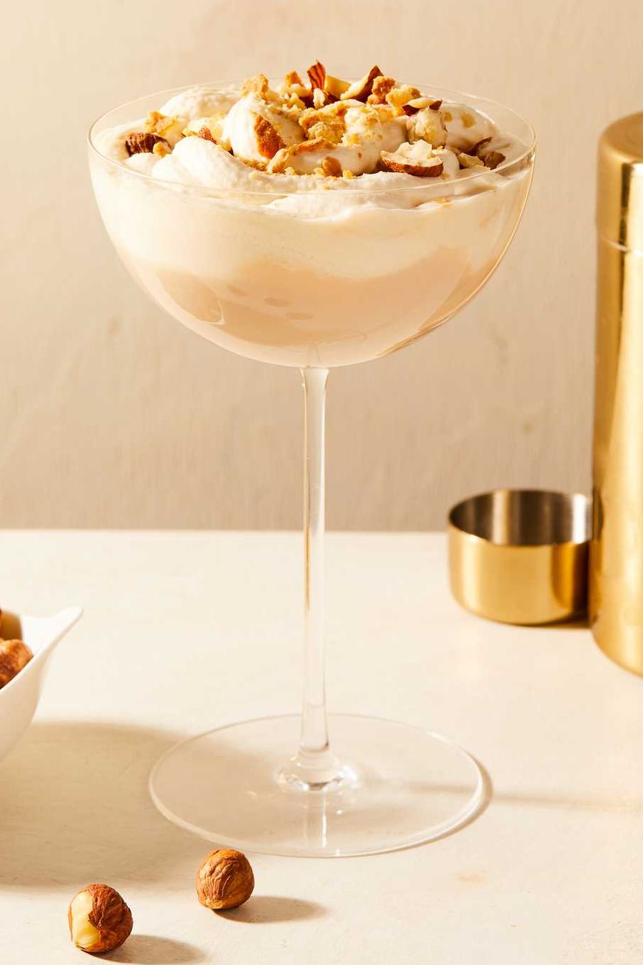 nutty irishman creamy cocktail topped with crushed hazelnuts in a coupe