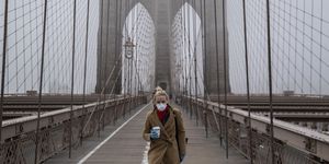 new york, ny   march 20 a woman wearing a mask walks the brooklyn bridge in the midst of the coronavirus covid 19 outbreak  on march 20, 2020 in new york city the economic situation in the city continued to decline as new york gov andrew cuomo ordered all nonessential businesses to keep all their workers at home and new york weighed a shelter in place order for the entire city photo by victor j bluegetty images