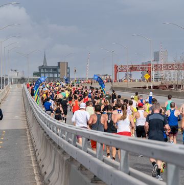 a crowd of runners on a bridge