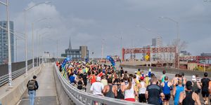 a crowd of runners on a bridge
