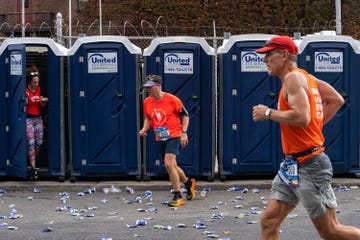 runners leave bathroom stalls during the new york city marathon in 2022