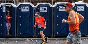 runners leave bathroom stalls during the new york city marathon in 2022