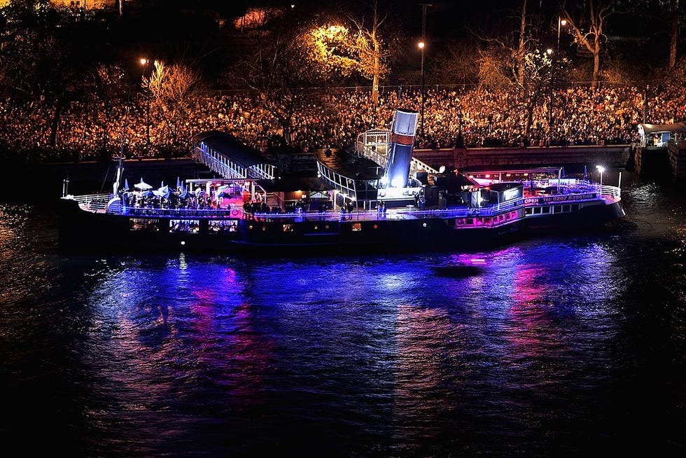 people gather on boat on the thames for nye