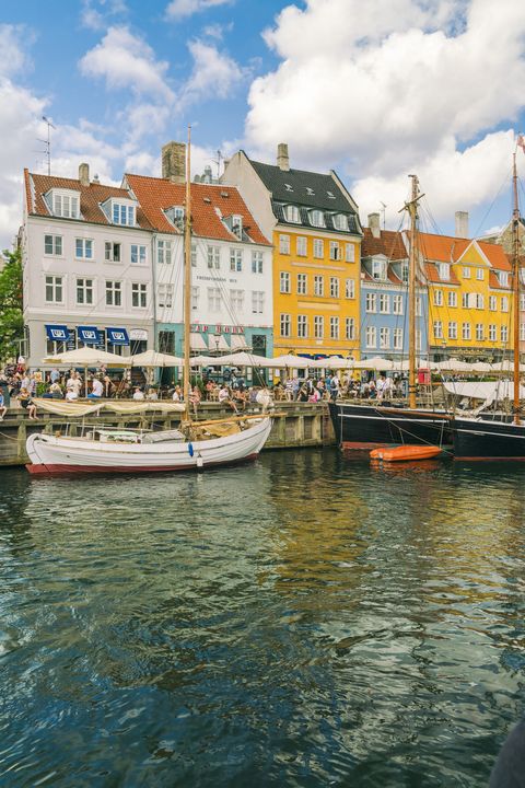 nyhavn with old colourful buildings and boats anchored in summer, copenhagen, denmark, europe
