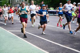 a crowd of runners in a road running race