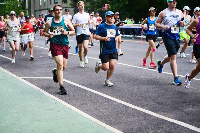 a crowd of runners in a road running race