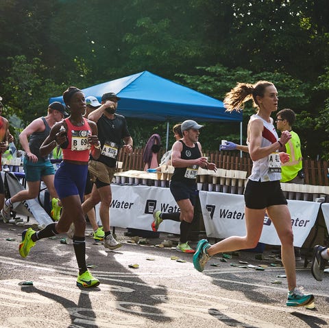 RWD a group of runners grab water during a race