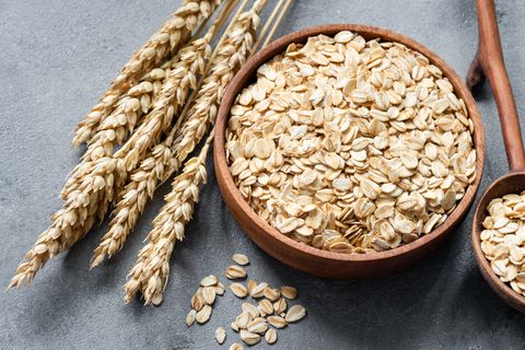 oat flakes or rolled oats in wooden bowl