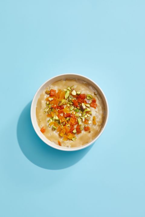 oatmeal with pistachios and apricots on a blue background