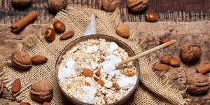 oatmeal cereals with grated coconut and nuts in a bowl of coconut shell