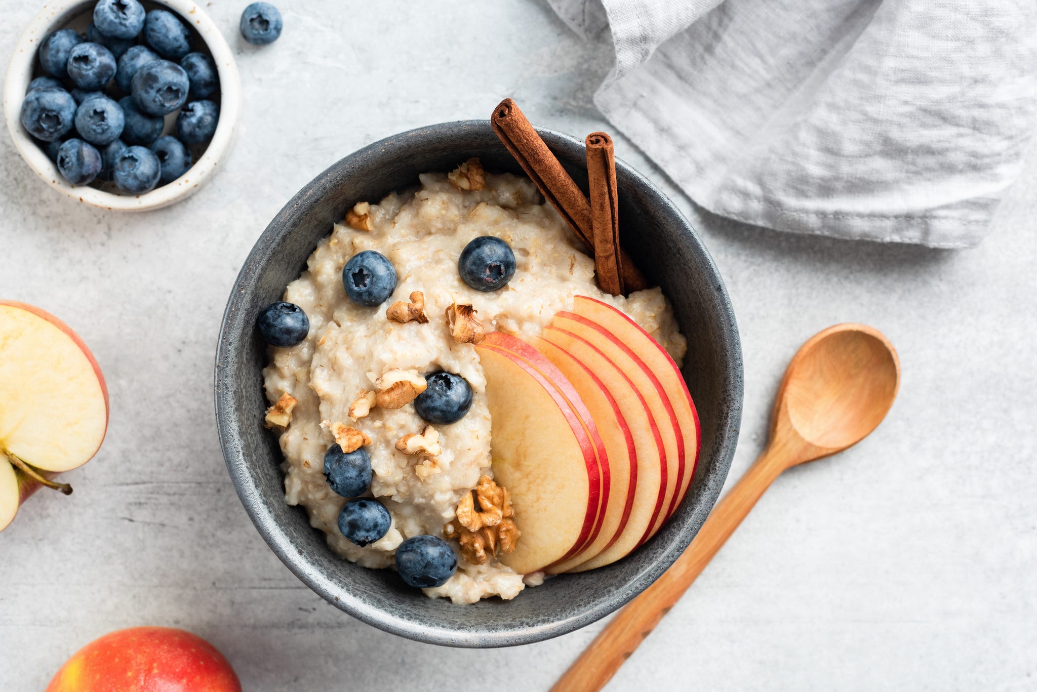 porridge recipes bowl of porridge with apple, blueberries and cinnamon