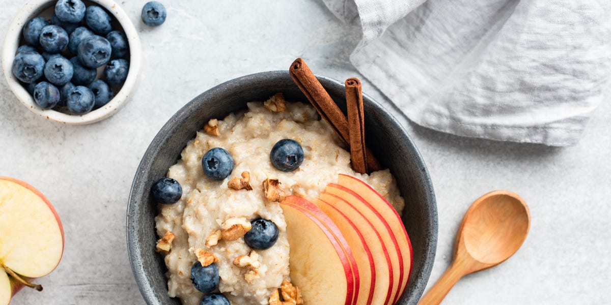 porridge recipes bowl of porridge with apple, blueberries and cinnamon