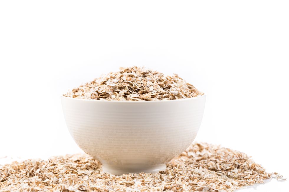 dry oatmeal overflowing in a white bowl