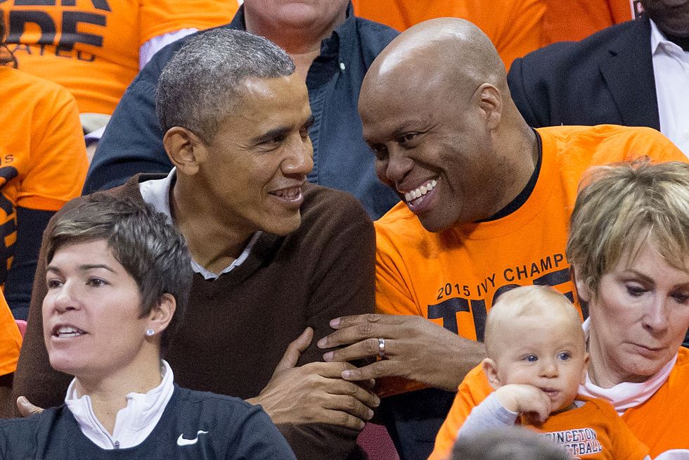 college park, md   march 21  afp out us president barack obama l sits beside his brother in law craig robinson while attending the green bay versus princeton womens college basketball game in the first round of the ncaa tournament, march 21, 2015 in college park, maryland president barack obamas niece leslie robinson plays for princeton  photo by michael reynolds poolgetty images