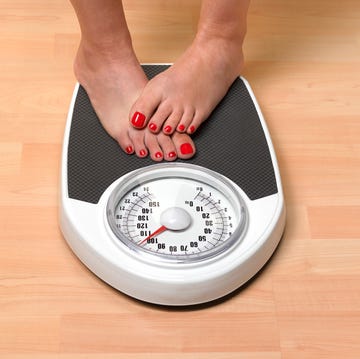 obese woman weighing herself