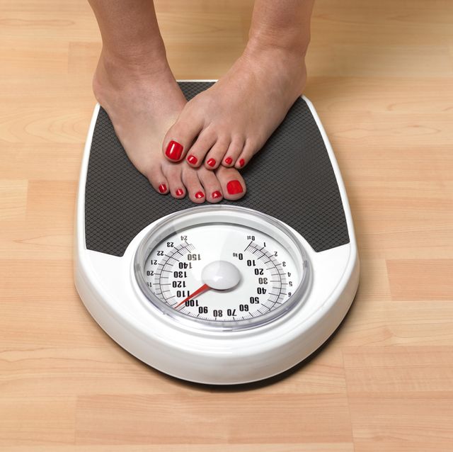 obese woman weighing herself