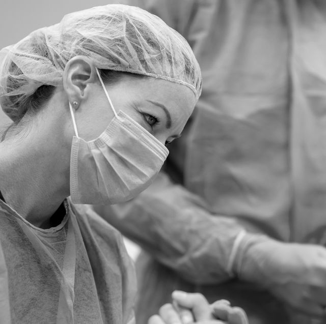 an ob gyn holding a patients hand