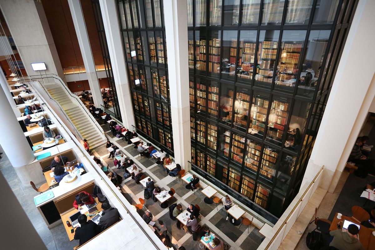 Bezoekers zitten in het caf van de British Library waar onderzoekers toegang hebben tot miljoenen gedigitaliseerde paginas uit de archieven