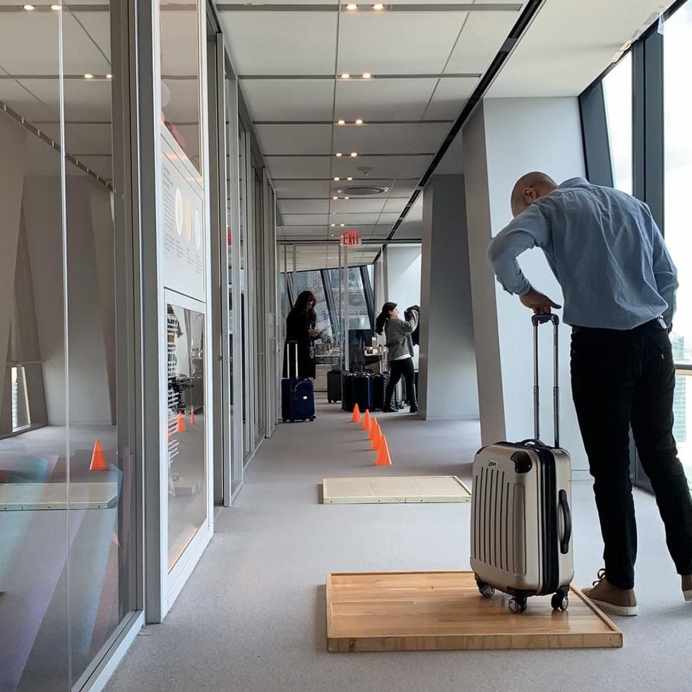 a luggage tester trying a suitcase on different floor surfaces in our obstacle course