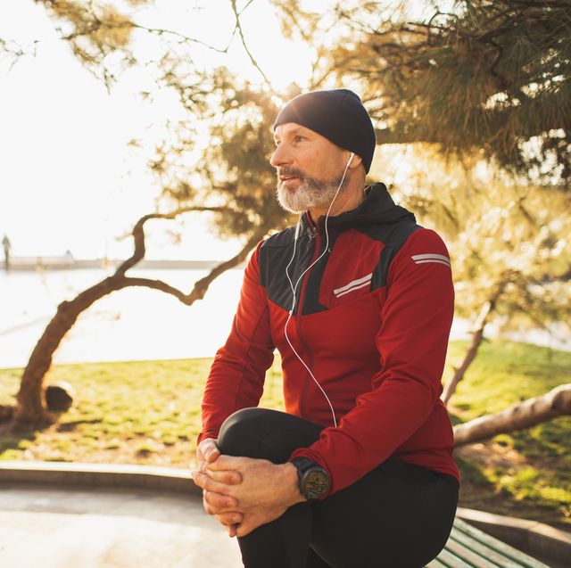 wellbeing and vitality, active healthy lifestyle of elderly people mature man with beard training outdoors in park in morning stretching and warming up body serious and concentrated winter season