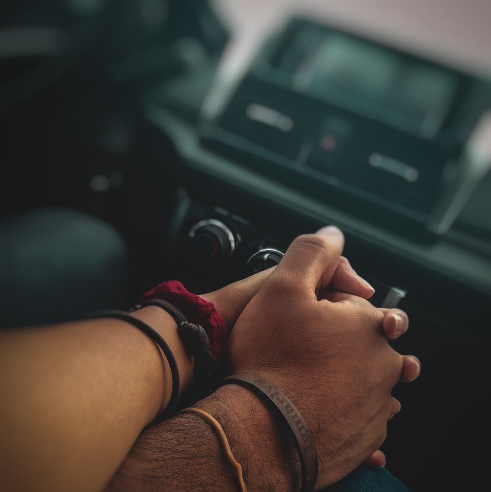couple holding hands on road trip