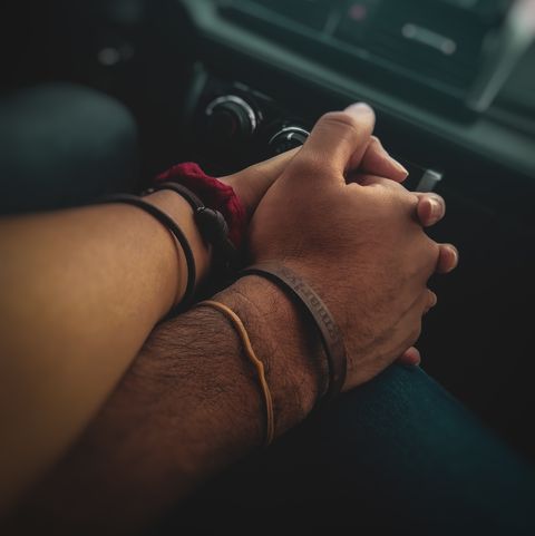couple holding hands on road trip