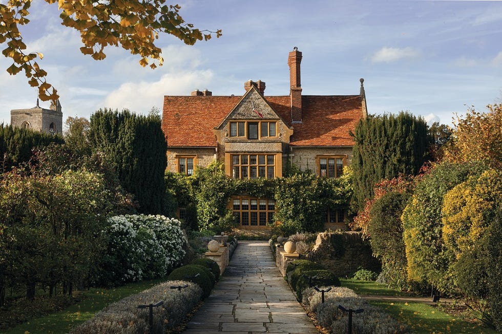 a large brick house with a garden in front of it