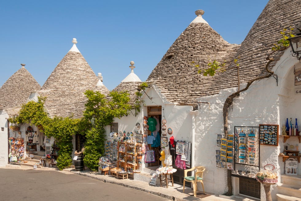 trulli buildings and shops, via monte san michele, rione monti, alberobello, bari province, puglia region, italy